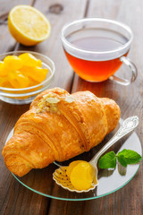 cup of tea, croissant, lemon and mint