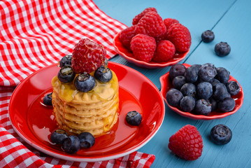 Fresh raspberries and blueberries on the cookies