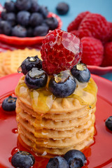 Fresh raspberries and blueberries on the cookies