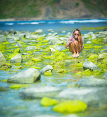 Woman Walks Alone on a Green Reef