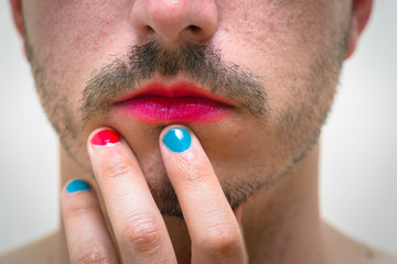 Close up of man with lipstick and nail polish