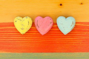 Fototapeta na wymiar Love Valentine's Hearts on Wooden Texture Painted Board Backgrou