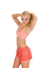 Fototapeta premium blond woman orange shorts fitness hands hair look down