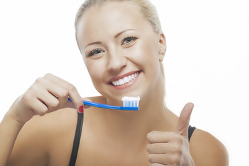 Portrait of Happy Blond Caucasian Woman Cleaning Her Teeth with