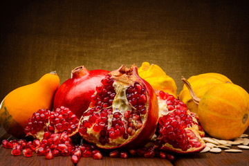 pumpkin and pomegranate on fabric background