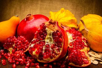 pumpkin and pomegranate on fabric background
