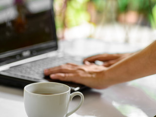 Coffee cup and laptop for business, Selective focus on coffee.