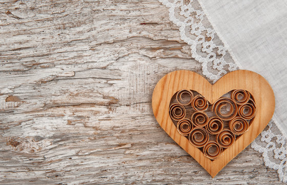 Wooden heart and linen fabric on the old wood