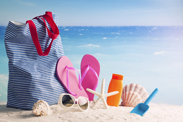 beach bag, sunblock and starfish on the beach