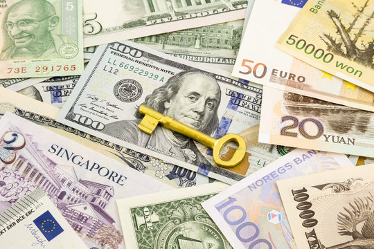 golden key  and world currency money banknotes