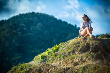 Naklejka premium Girl Sitting on the Beach