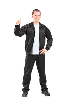 Young Man In Black Tracksuit Giving A Thumb Up