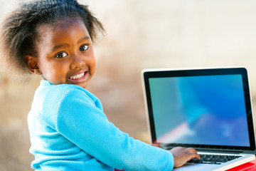 Afican child learning on computer