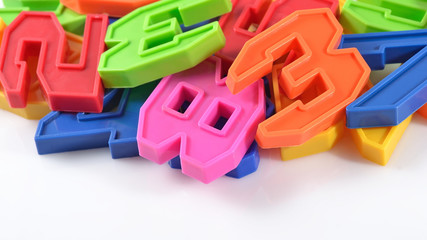 Colorful plastic numbers on white
