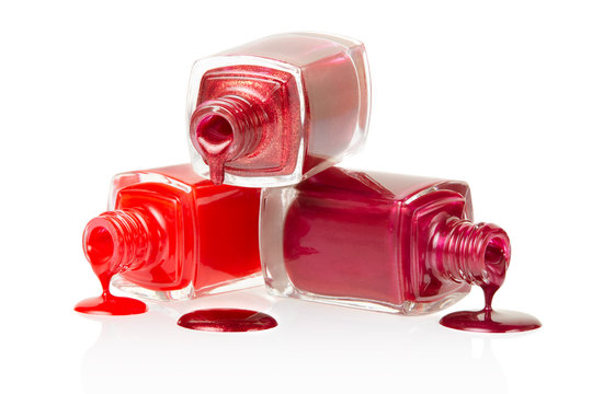 Fototapeta Red nail polish spilled on white background, clipping path