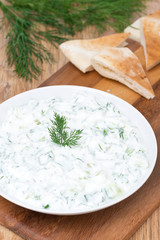 yoghurt sauce tzatziki with herbs, cucumber and garlic, vertical