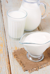 Dairy products on wooden background.