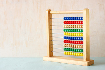 Beaded Abacus over wooden textured background  