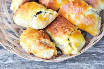 Freshly baked pies with a poppy-seed on old wooden table