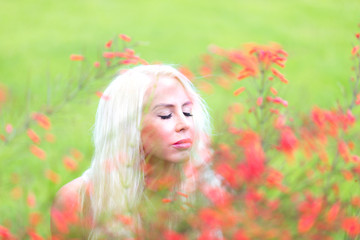 Obraz na płótnie Canvas Pretty Blonde Woman relaxing outdoor