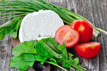 Cheese with tomatoes and arugula and onion