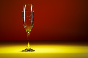 Glass of champagne on colorful background. Glass of bubbly.