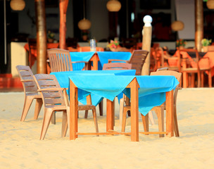 table with chairs on sandy beach