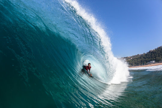 Surfing Body-Boarder Rides Inside Hollow Blue Wave
