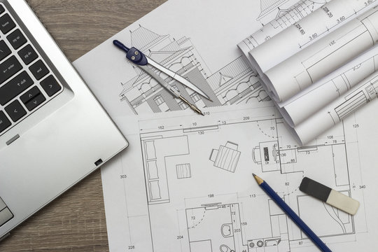 Architecture blueprints and laptop