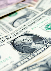 Background. A scattering of banknotes (dollars).