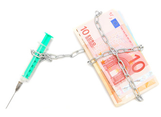 Syringe is chained by a chain to banknotes (euro).