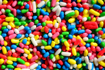 Fototapeta na wymiar Extreme macro shot of sweet candies spreading pastry decoration