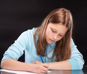 Teen girl writing