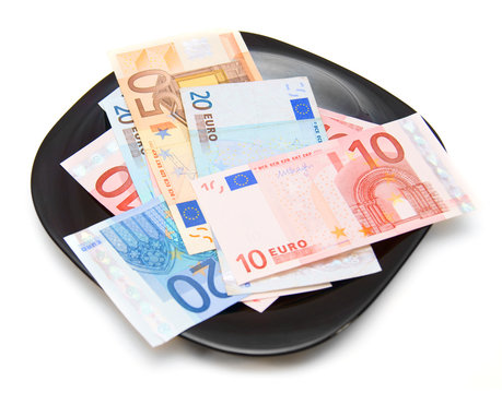 Euros of a banknote in a plate. On a white background.