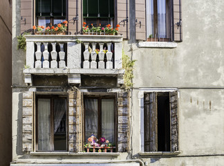 Fototapeta na wymiar Venetian windows with flowers