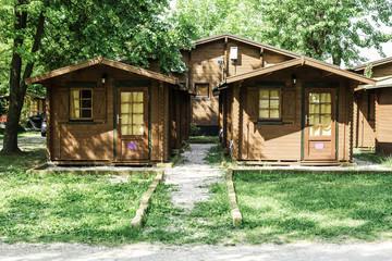 Wooden bungalows on campsite camping - obrazy, fototapety, plakaty