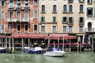 Fototapeta na wymiar Ancient buildings and boats in the channel in Venice
