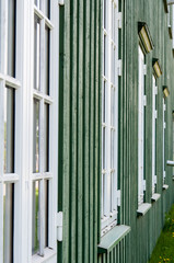 White wooden windows and green walls in Norway