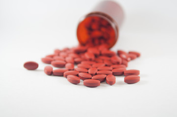 Brown tablet on medicine bottle background