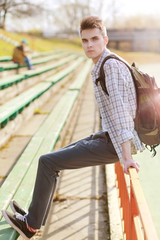 Outdoor lifestyle portrait of handsome guy with backpack summer