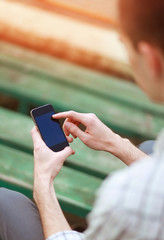 Male hand using a smart phone. Modern vintage hipster photo