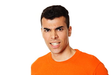Obraz premium Crazy young man at orange shirt showing teeth