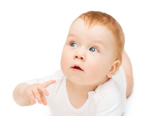 curious baby lying on floor and looking side