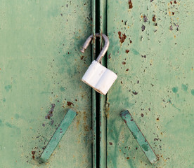 rusty lock on the green gate
