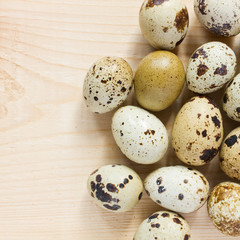 quail eggs over wooden background - top view