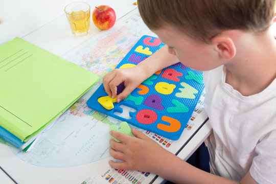 Boy learns with colorful letters