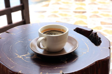 Cup of Black Coffee on a Wooden Table.