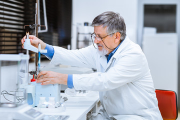 Senior male researcher carrying out scientific research in a lab