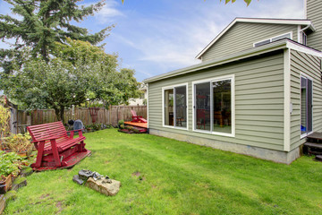 Fototapeta na wymiar Small backyard with red wooden bench