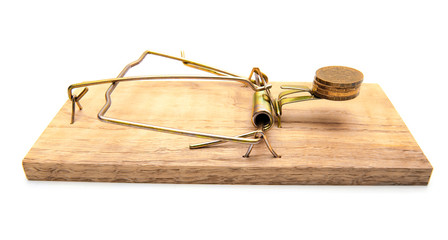 Coins in a mousetrap. On a white background.